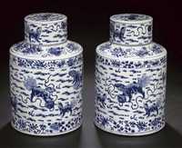 early 19th century A pair of blue and white cylindrical tea cannisters and covers